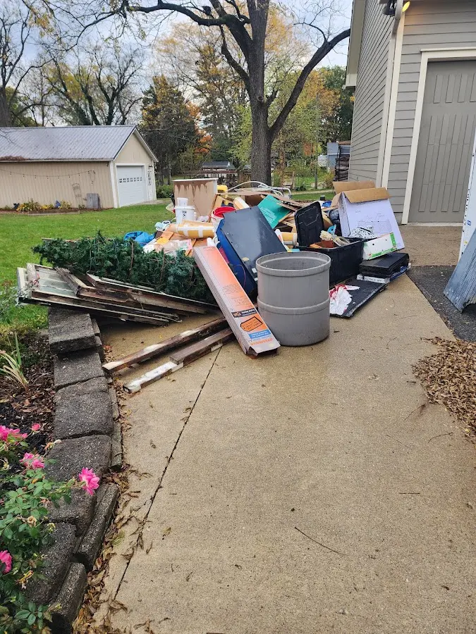 Dumpster being loaded with debris for 3 Yard Dumpster Rental in Waynesville